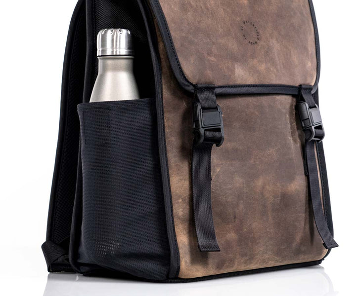 Magnetic side pockets stretch to accommodate water bottles